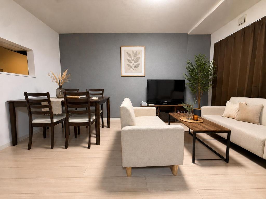 a living room with a couch and a table at Excel 美園 -FIX HOME- in Sapporo