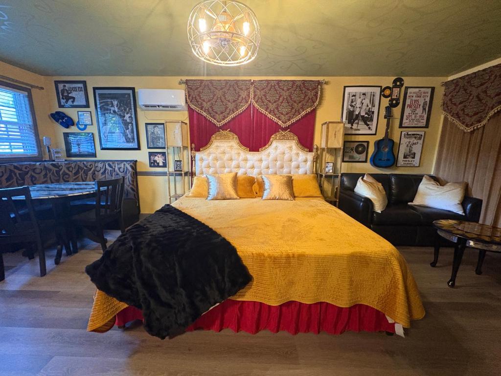 a bedroom with a large bed with a yellow bedspread at Historic Ziegler Inn and Suites with Whimsical Themed Rooms in New Bern