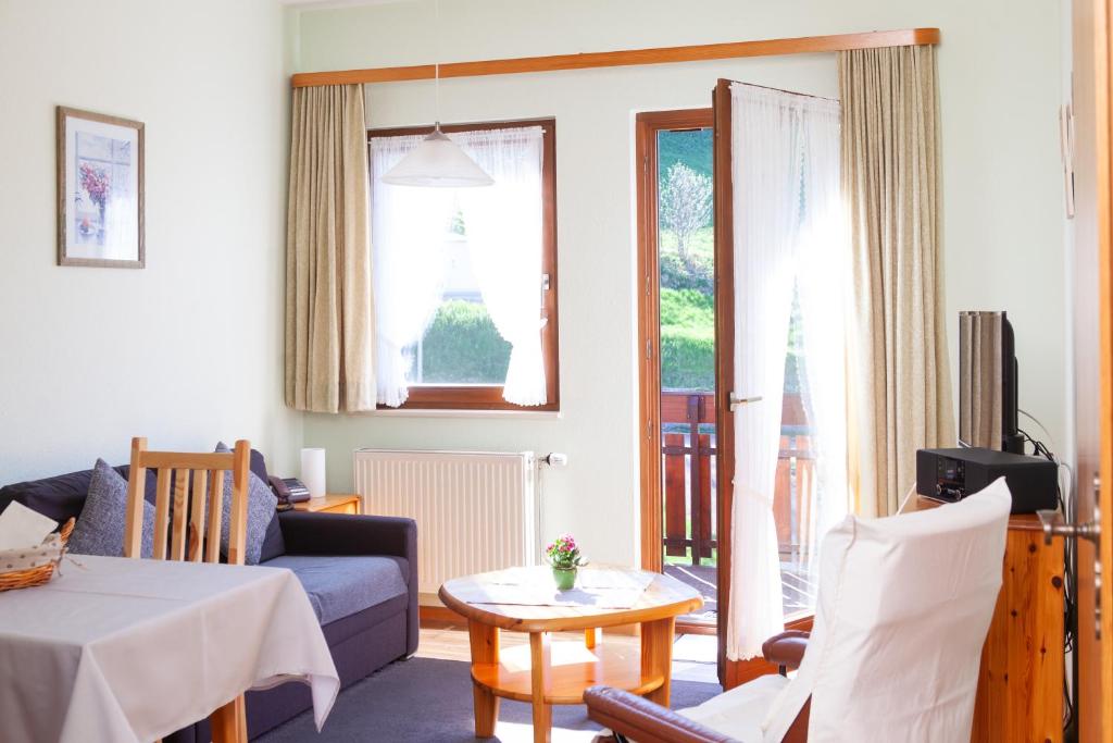 a living room with a couch and a table at Haus Keller Ferienwohnungen in Todtnauberg