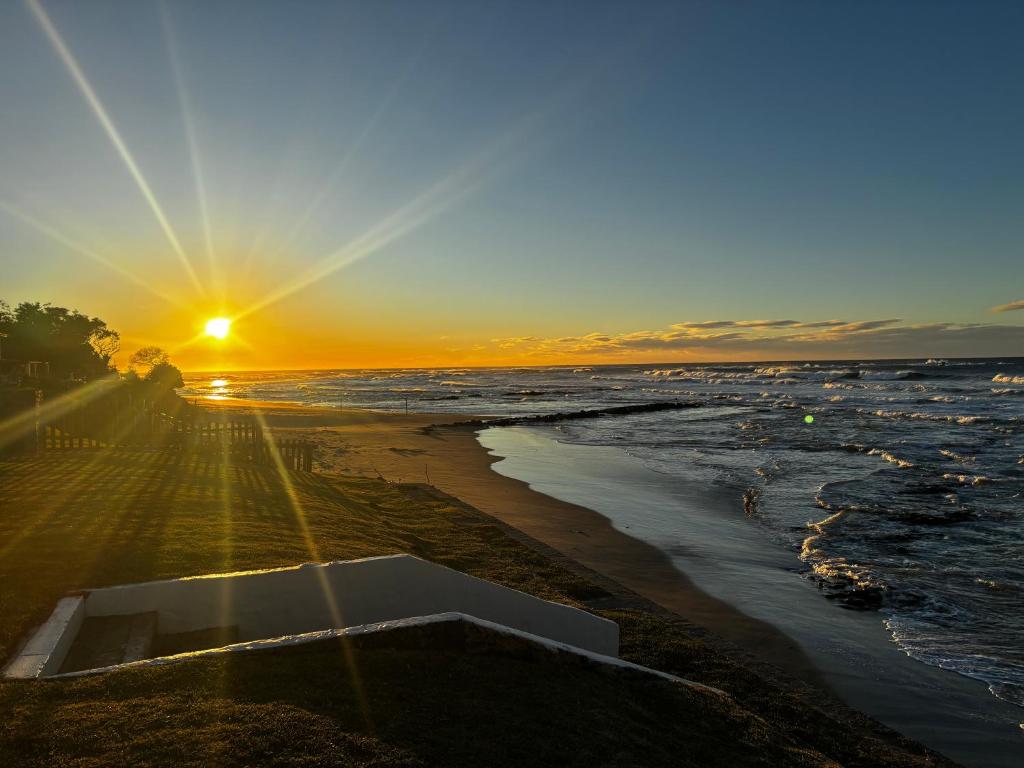 a sunset on a beach with the ocean at Kei Sands Nr 6 in Kei-mouth Village