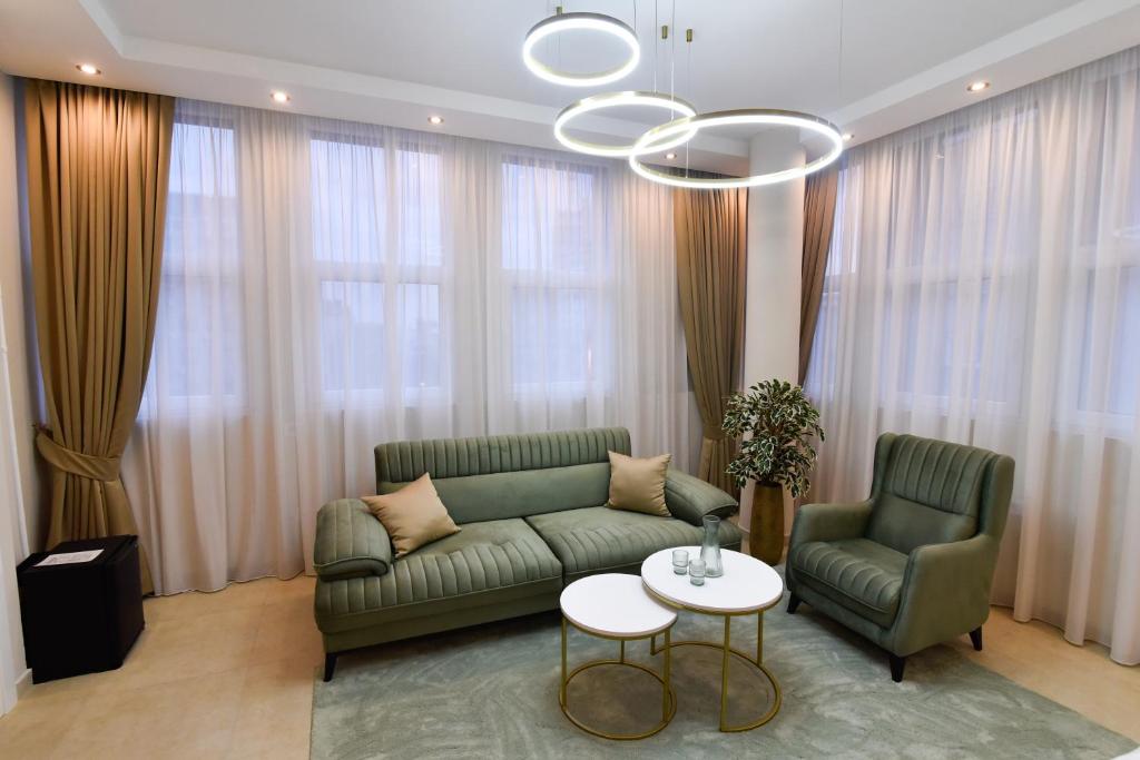 a living room with a green couch and two chairs at Dream Palace 2 in Belgrade