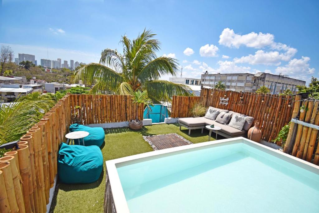 a small backyard with a swimming pool on a roof at Casa Nomis Cancun in Cancún