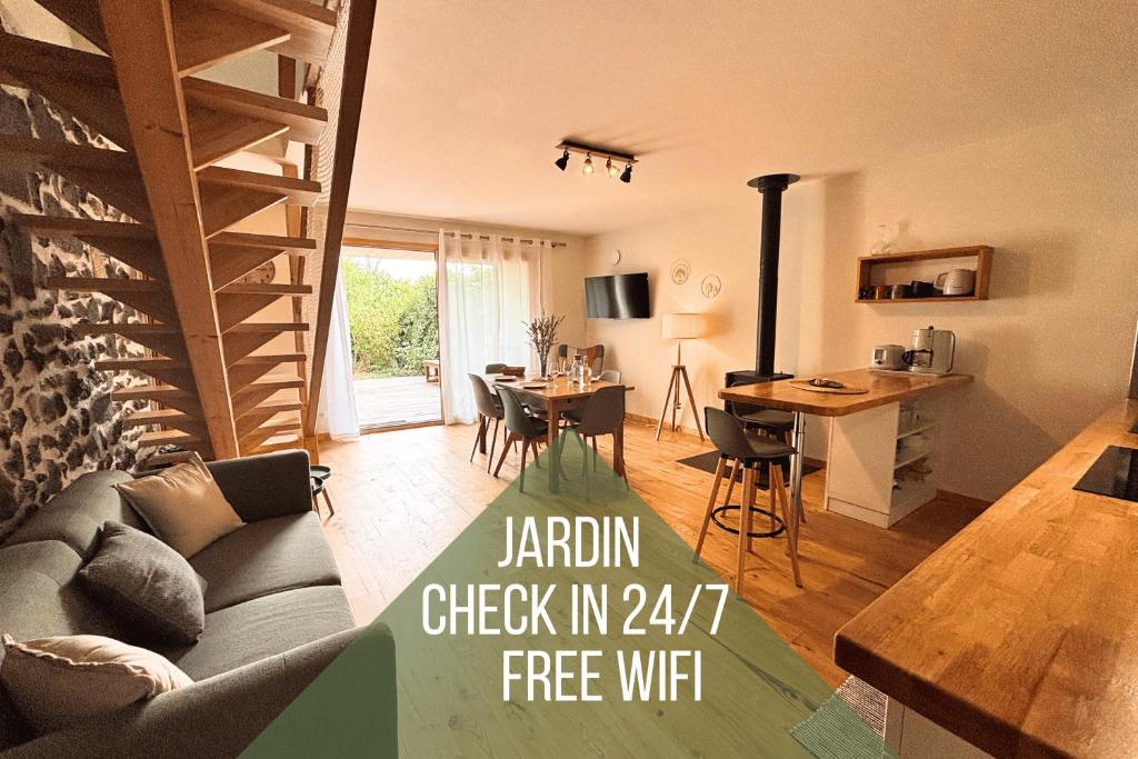 a living room with a couch and a table at L'Écrin Volvicien - Maison 4 pers - Terrasse - Jardin in Volvic