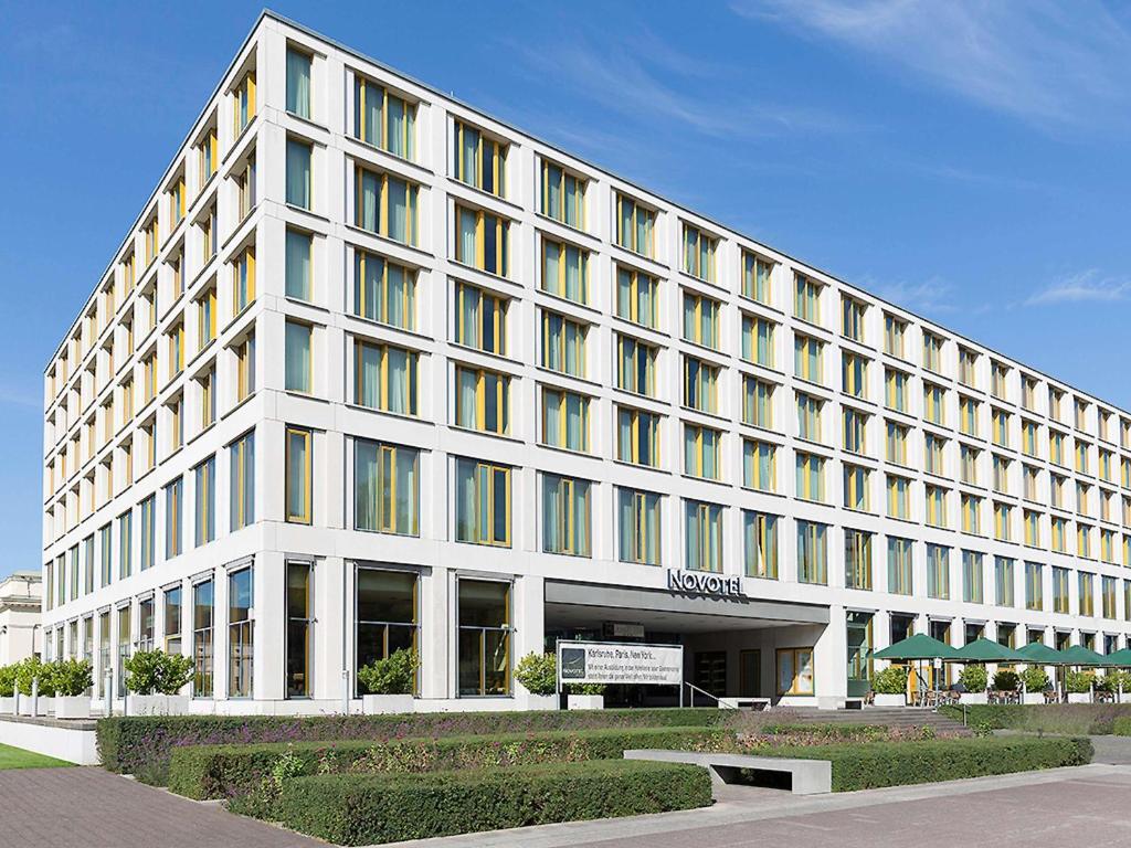 a large white building with a lot of windows at Novotel Karlsruhe City in Karlsruhe