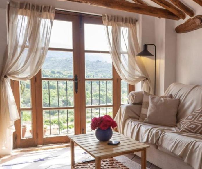 a living room with a couch and a large window at Casa del Lago in Restábal