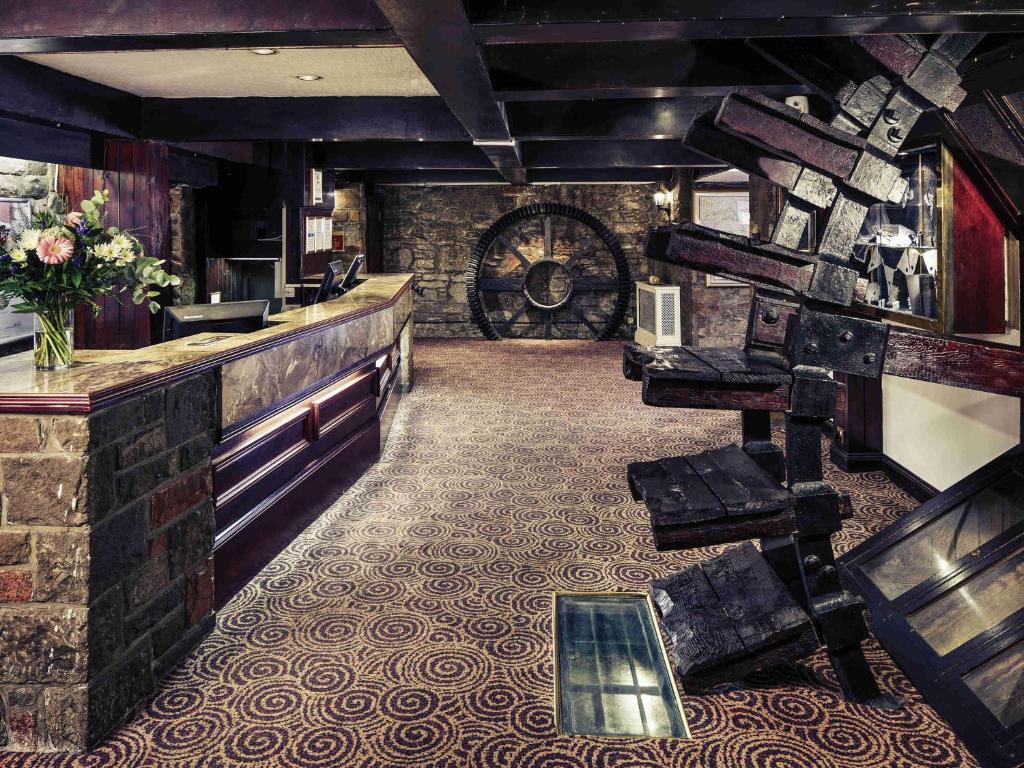a room with a bar and a wine cellar at Mercure Perth Hotel in Perth