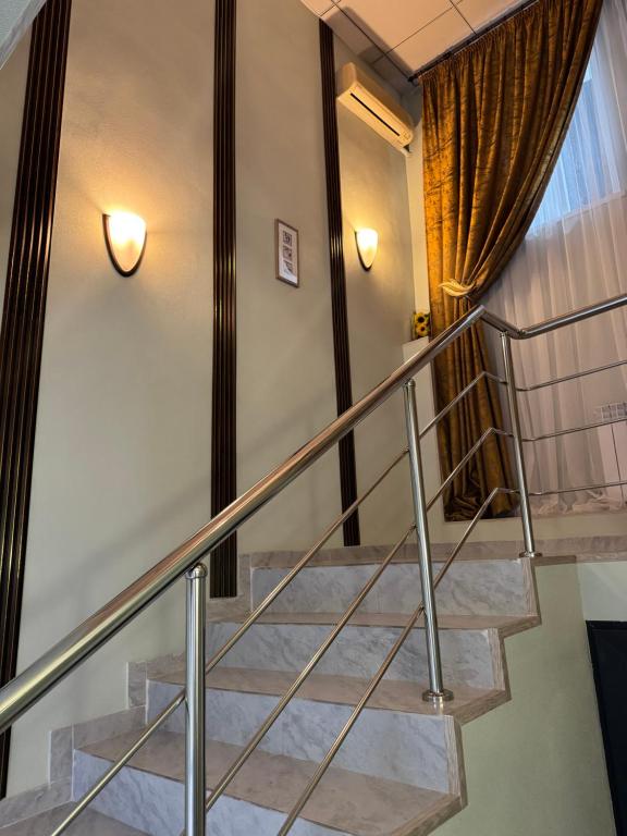 a staircase in a house with metal railings at Inju in Temirtaū