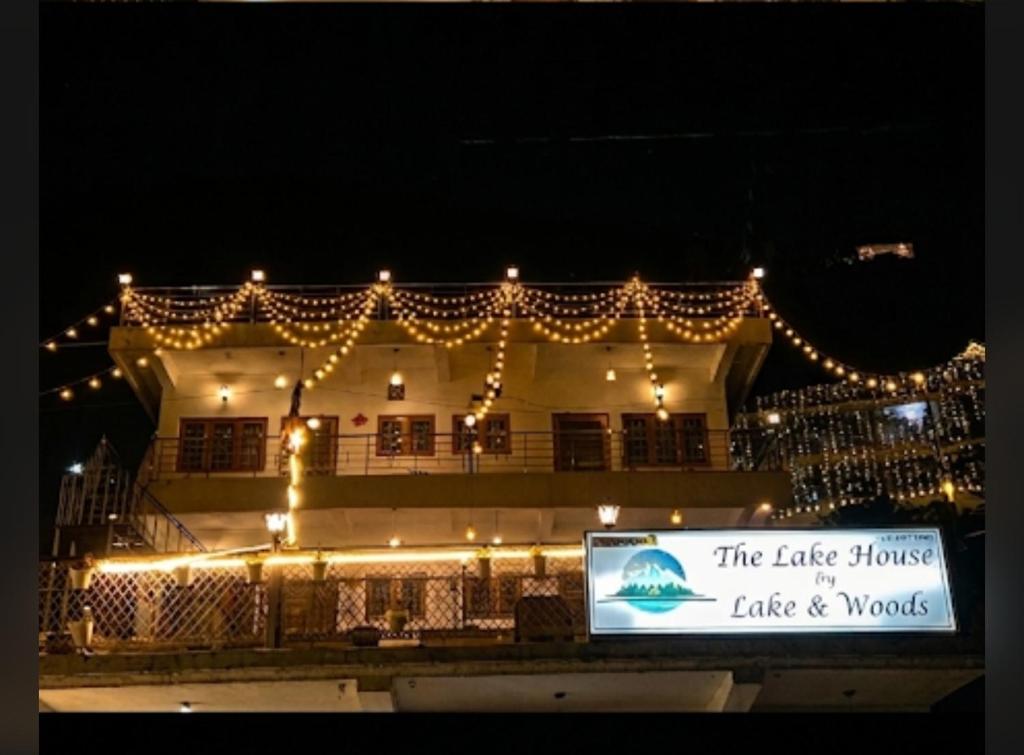 a large building with lights on it at night at The lake house in Bhīm Tāl