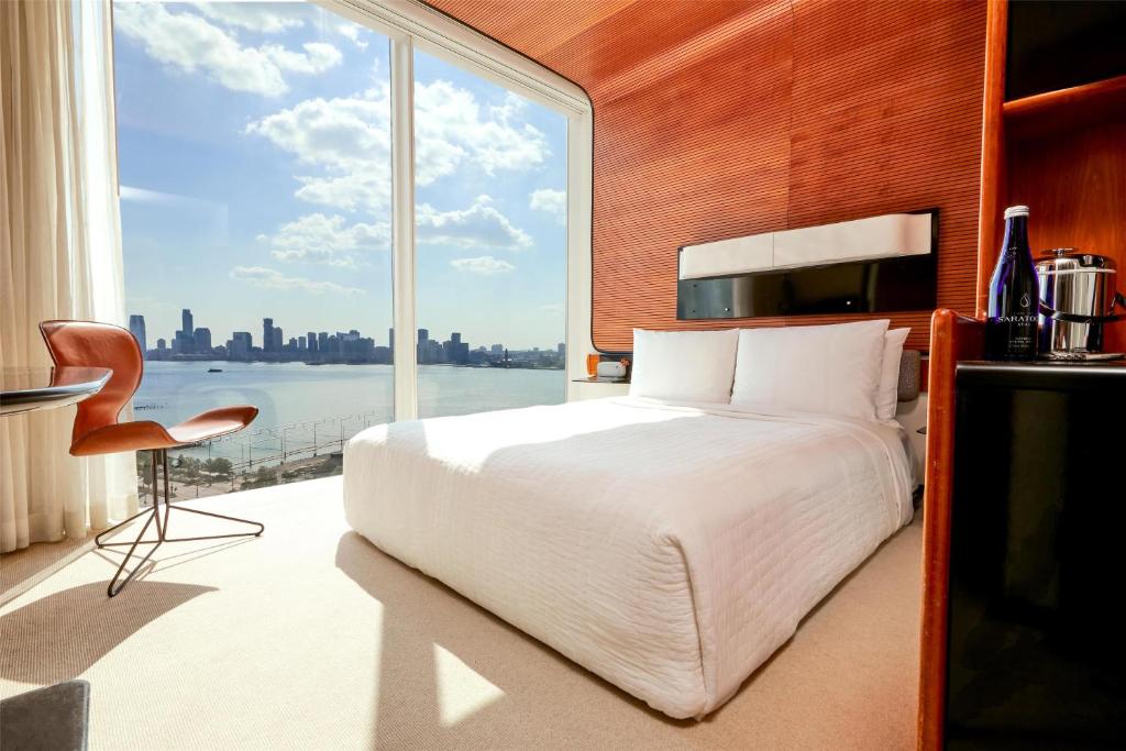 a bedroom with a large bed and a large window at The Standard, High Line New York in New York
