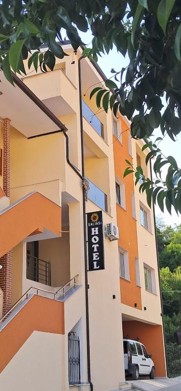 a building with a sign in front of it at Saliasi hotel&apartament in Poliçan