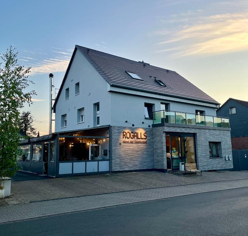 a white building with a rockies sign on it at Haus der Gastlichkeit in Ratingen
