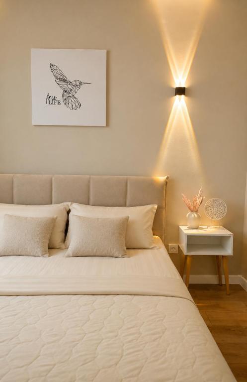 a bedroom with a bed with a bird drawing on the wall at Ауельбекова 120 in Kokshetau