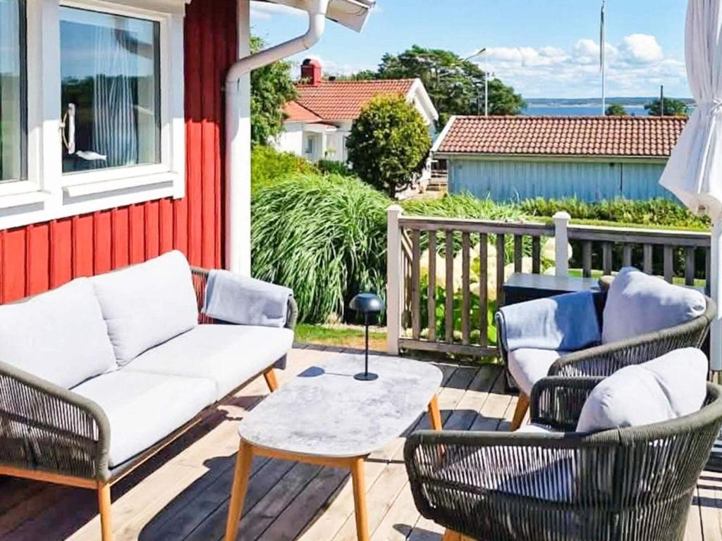 a porch with two chairs and a couch and a table at 4 star holiday home in onsala in Onsala