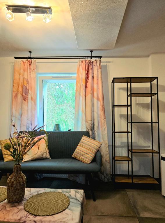 a living room with a couch and a window at Rosa in Rydułtowy