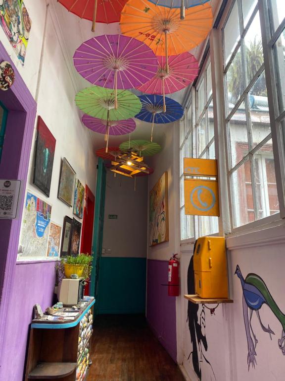 a hallway with colorful umbrellas hanging from the ceiling at La Mancha Art Hostel - Cerro Alegre - Valparaiso in Valparaíso