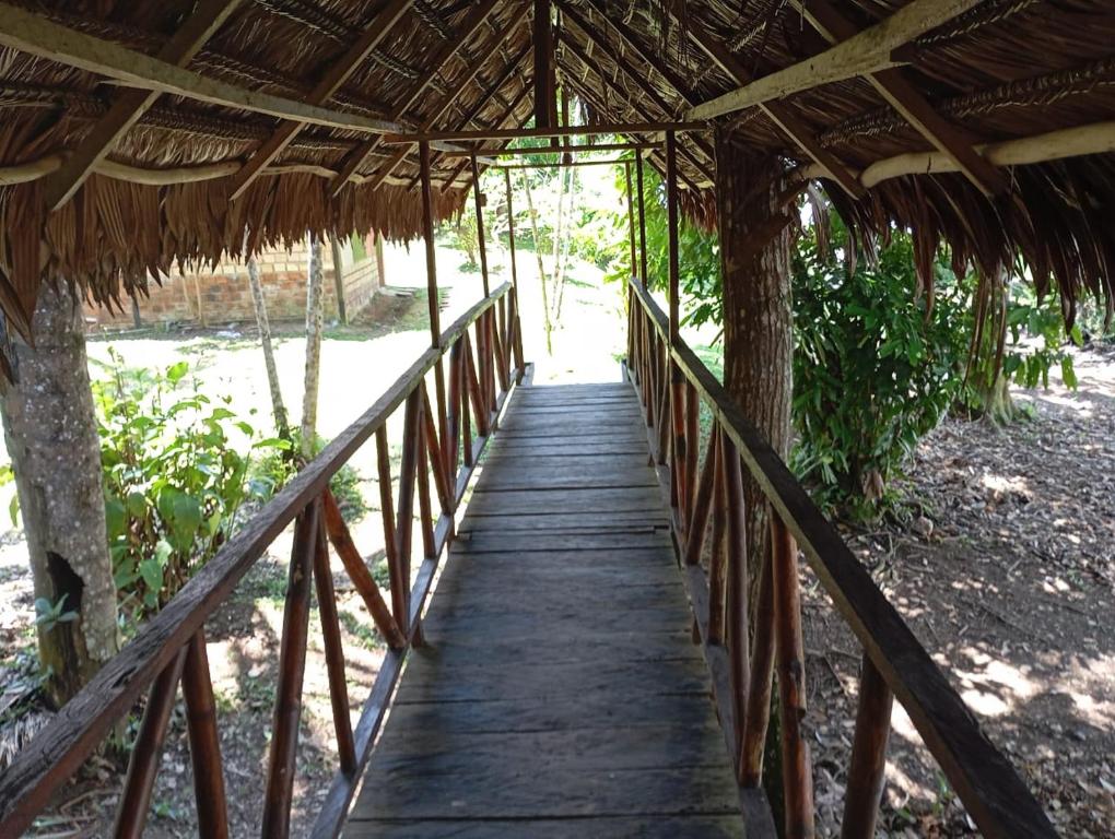 a bridge over a wooden walkway in a resort at Amazon Lodge and Expeditions in Iquitos