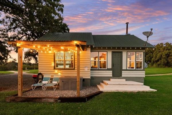 a tiny house with a gazebo and lights on it at Cedar Nest - Lakefront Cabin Retreat in Madill