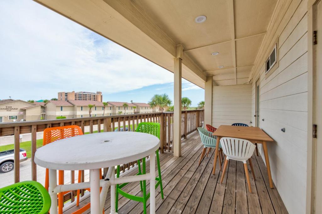 a patio with a table and chairs on a deck at M & S Turtle Cove in Port Aransas