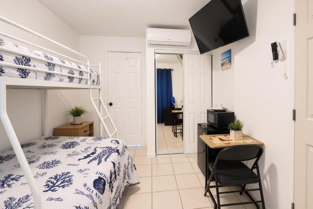 a bedroom with a bed and a desk and a bunk bed at Coco Sol 2 by MyMiamiStay in Miami