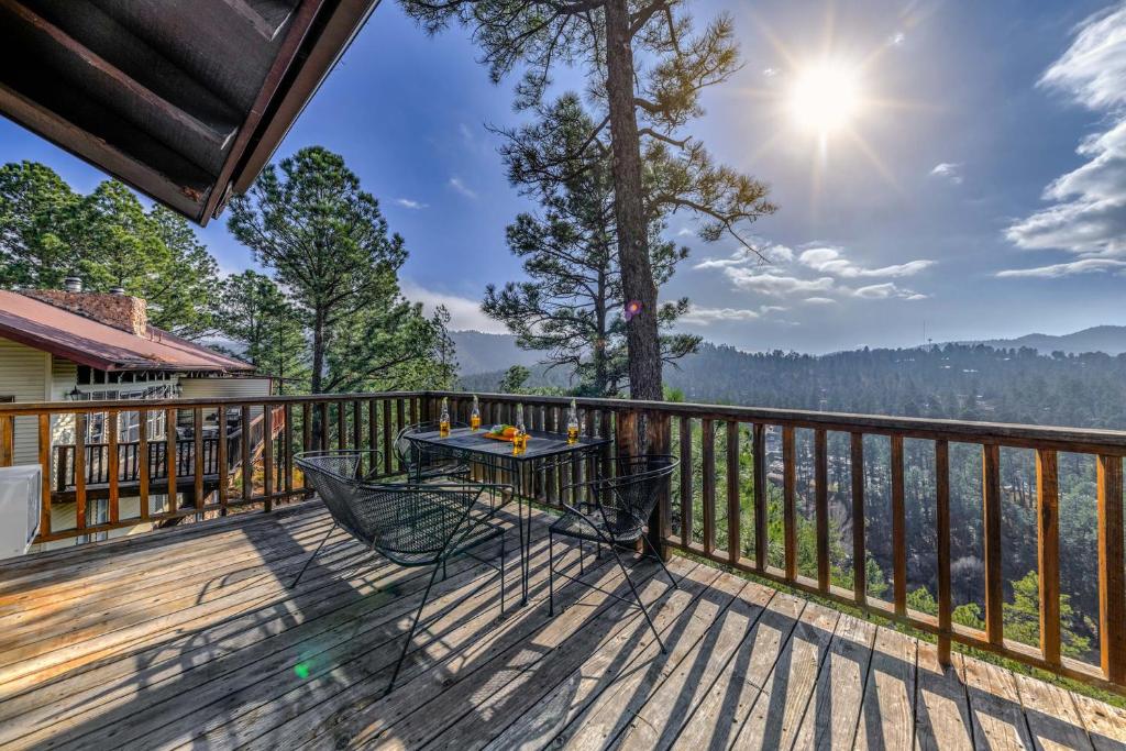 a table on a deck with a view of the water at Hold Your Horses in Ruidoso