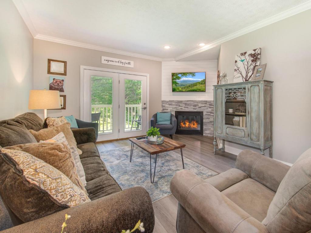 a living room with two couches and a fireplace at Lazy Bears Den 2103 in Pigeon Forge