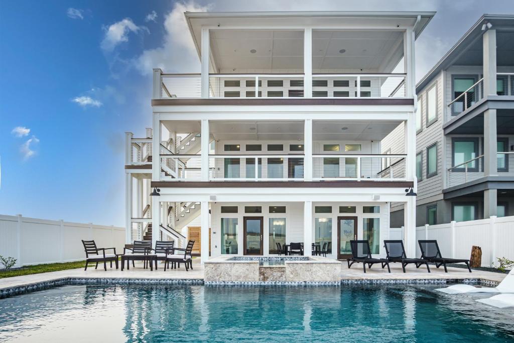 a large house with a swimming pool in front of it at The Sanctuary in Padre Island