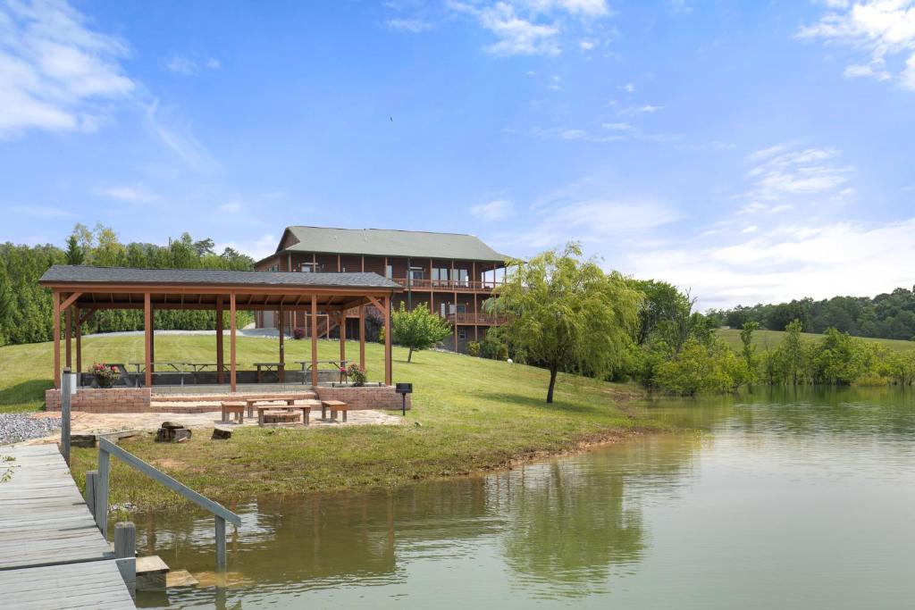 a building with a gazebo next to a river at Wonderland Cove in Dandridge