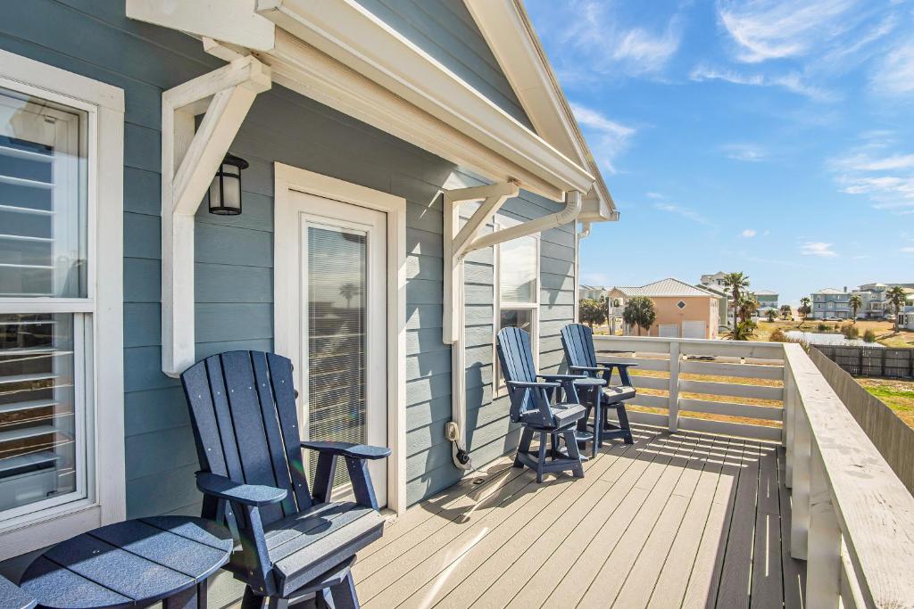 three chairs sitting on a porch of a house at Downtime in Padre Island