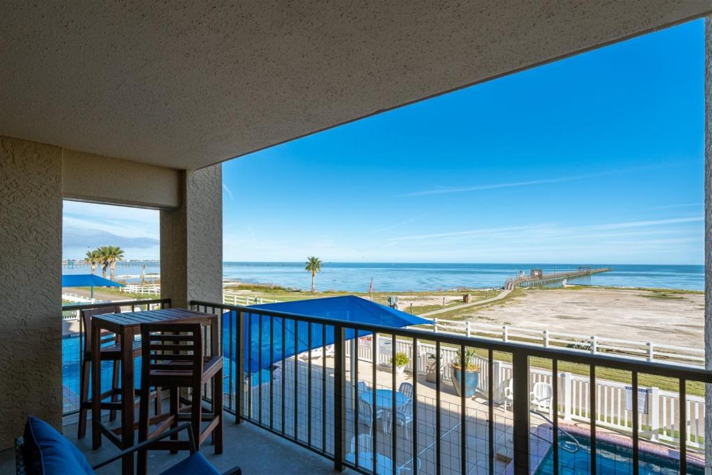a balcony with a view of the beach at Laguna Reef #212 - Shore 2 Please in Rockport