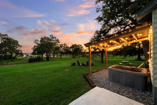a gazebo with a hot tub in a yard at Willow Heaven - Lakefront Cabin Escape in Madill