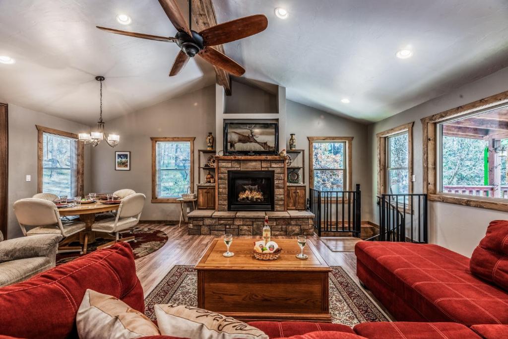 a living room with a red couch and a fireplace at The Great Escape in Ruidoso