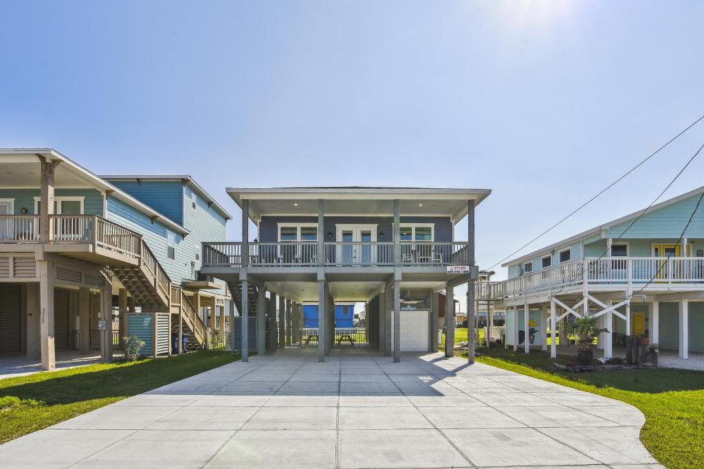 an apartment building with balconies and a walkway at Sandy Cheeks Surfside in Surfside Beach