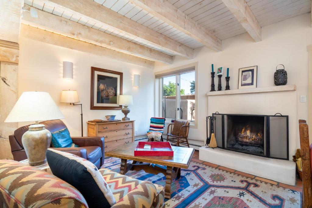 a living room with a couch and a fireplace at Las Brisas 24 in Santa Fe