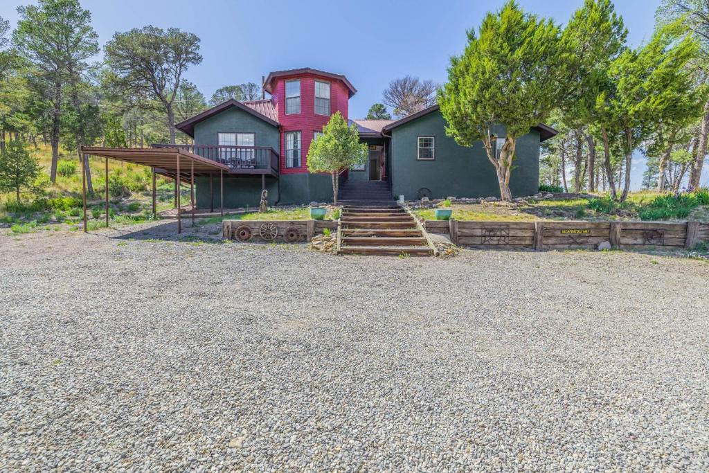 a home with a red and green house at Castle House in Ruidoso