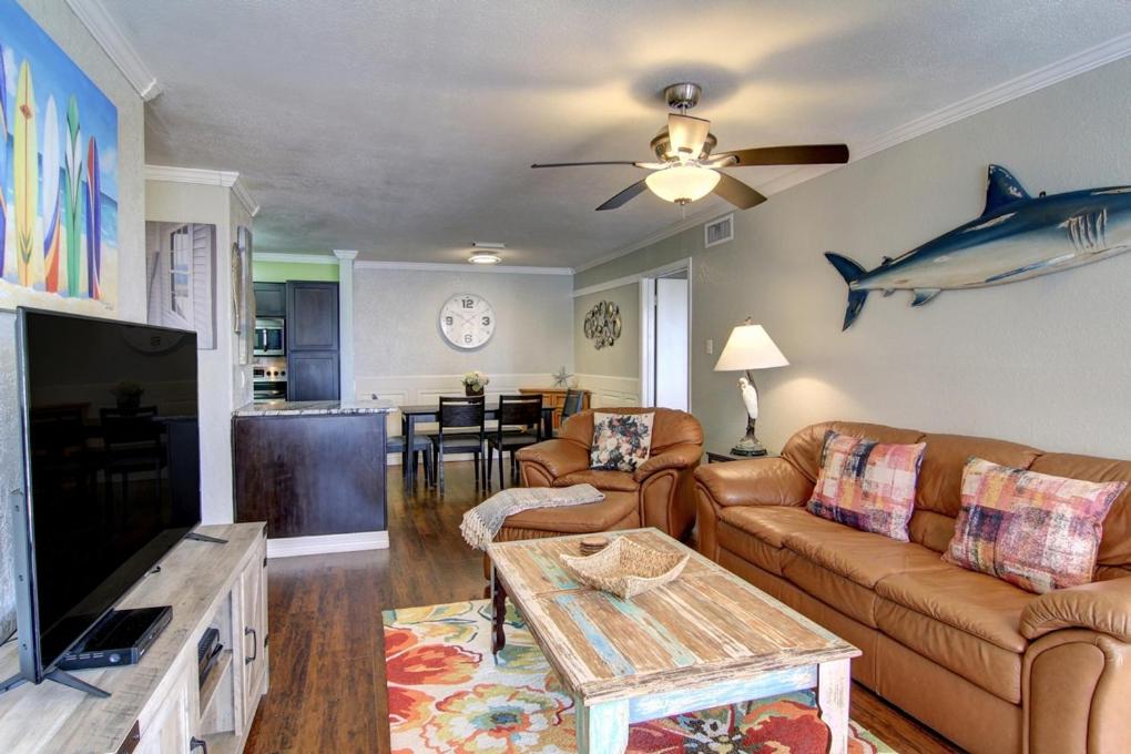 a living room with a shark on the wall at Sand In Your Toes in Mustang Beach
