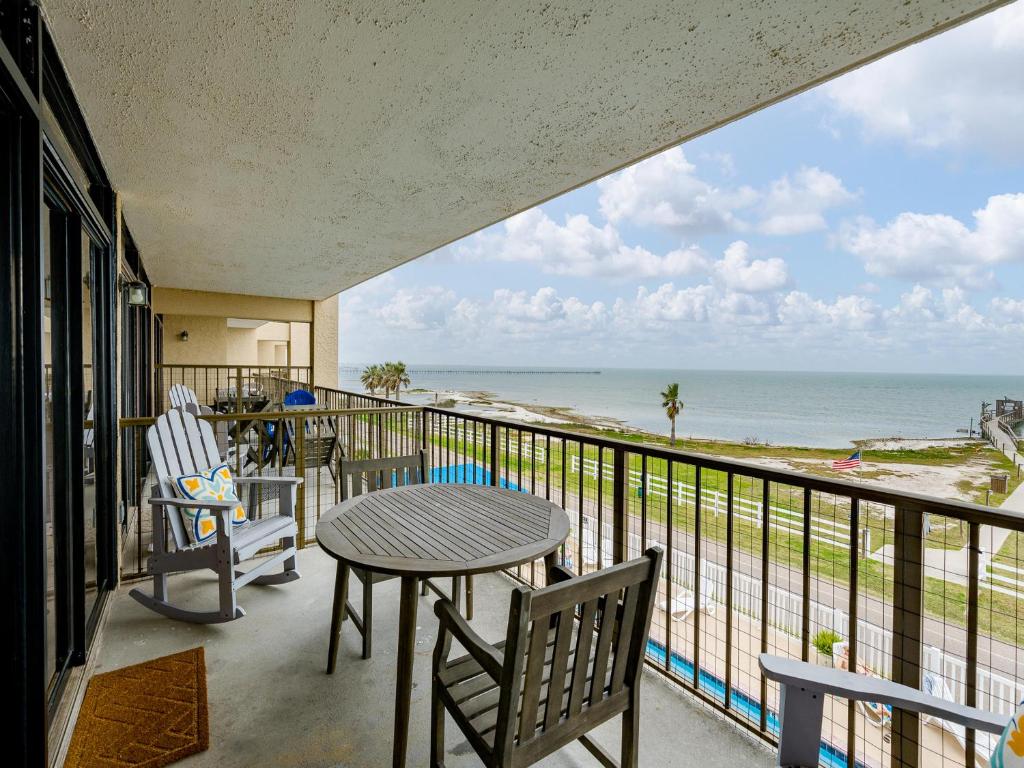 a balcony with a table and chairs and the ocean at LR 309 - Ms, Annies Oasis in Rockport