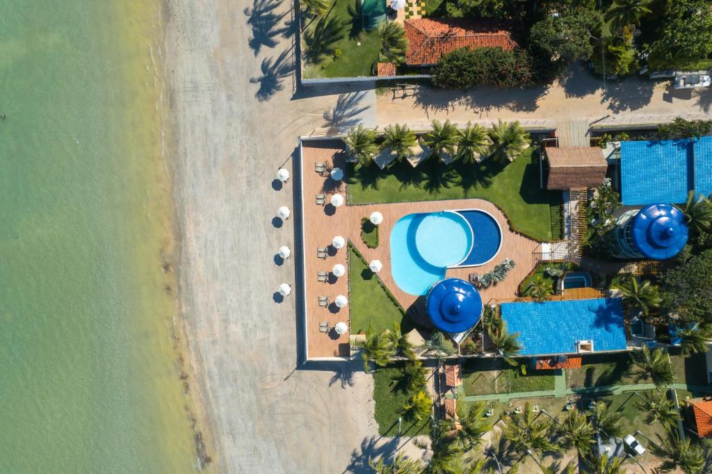 an aerial view of a resort with a swimming pool at Mansao in Maragogi