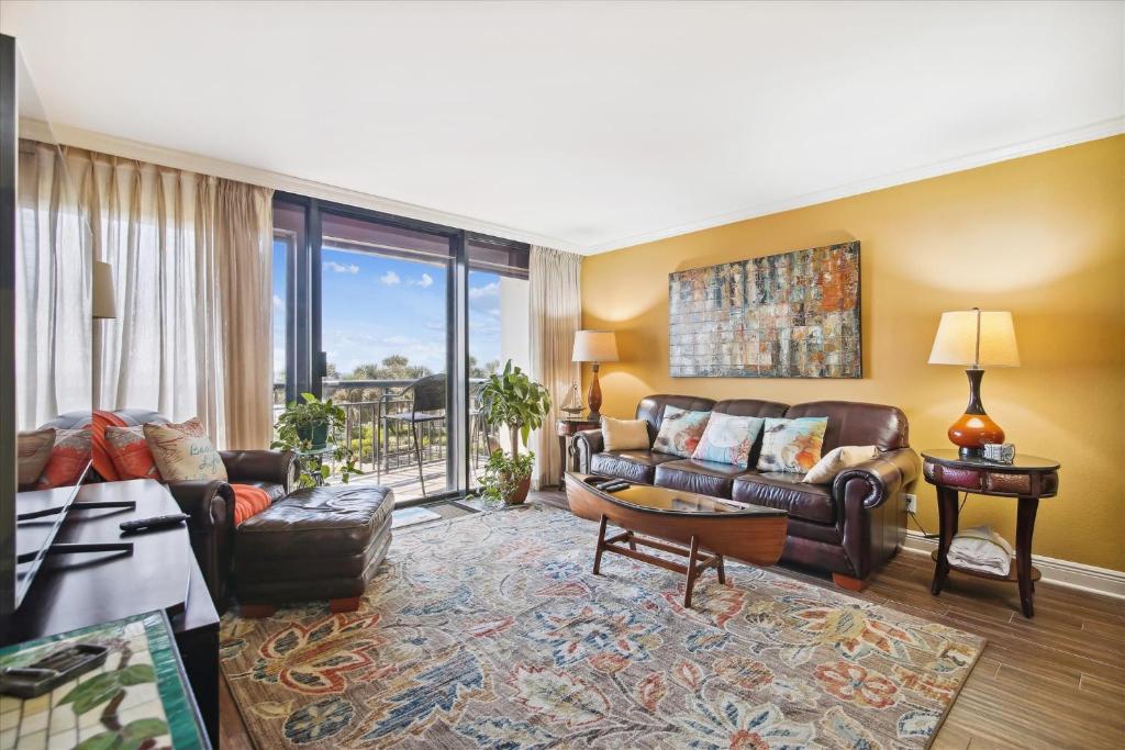 a living room with a couch and a table at San Luis Resort 533 - Luis Laid Back in Galveston