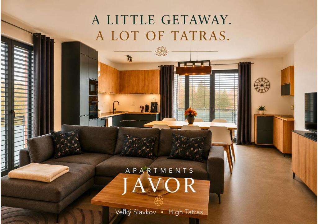 a living room with a couch and a kitchen at Apartments Javor in Veľký Slavkov