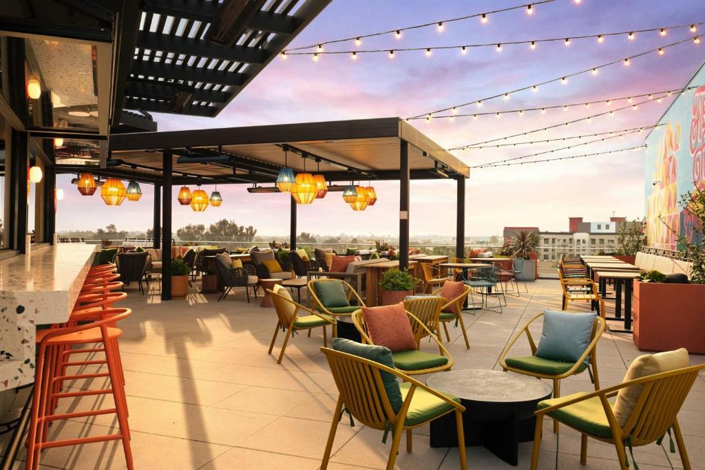 a rooftop patio with chairs and tables and lights at SpringHill Suites by Marriott Ventura Oxnard in Oxnard
