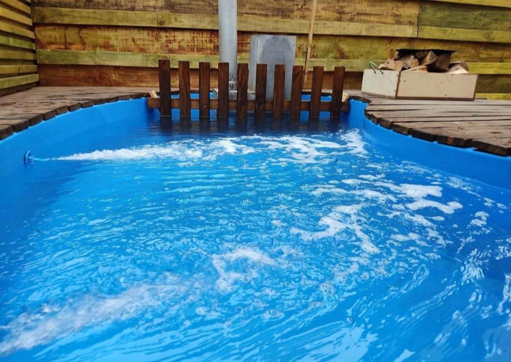 a swimming pool with two chairs in the water at Hospedaje Naomi in Valparaíso