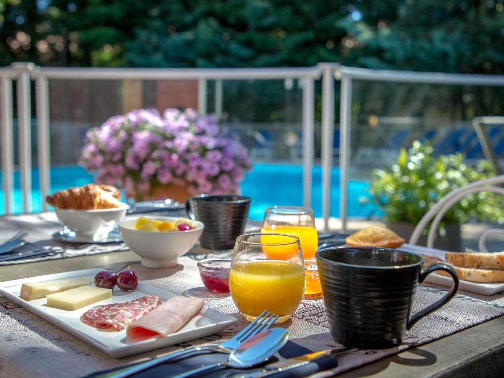 a table with breakfast foods and drinks on it at ibis Brignoles Provence Verte in Brignoles