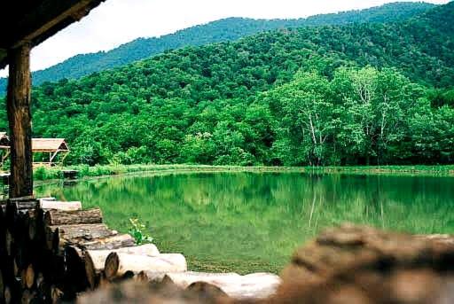 a view of a lake with a mountain in the background at Northern City Hotel in Zaqatala