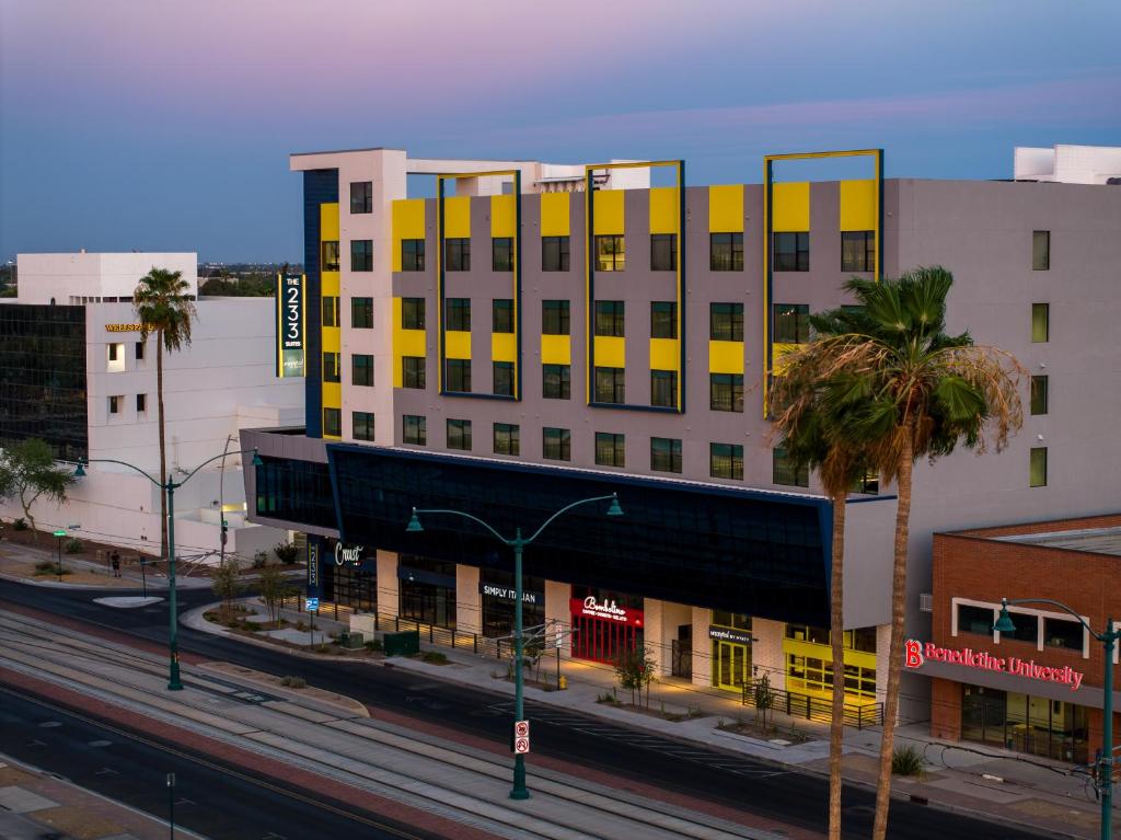 a yellow and white building on a city street at The 233 Suites Unscripted By Hyatt in Mesa