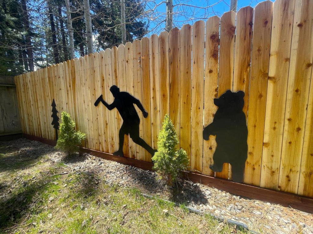 a shadow of a man running on a fence at Bear Claw Trails in Lake Tahoe Airport