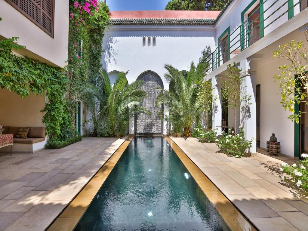an indoor pool in a courtyard of a house at Riad Oasis 3 in Marrakesh