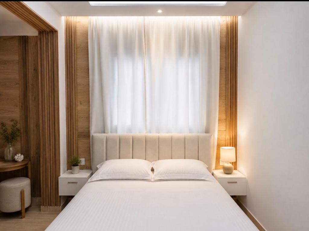 a bedroom with a large white bed and a window at ANN World in Vlorë