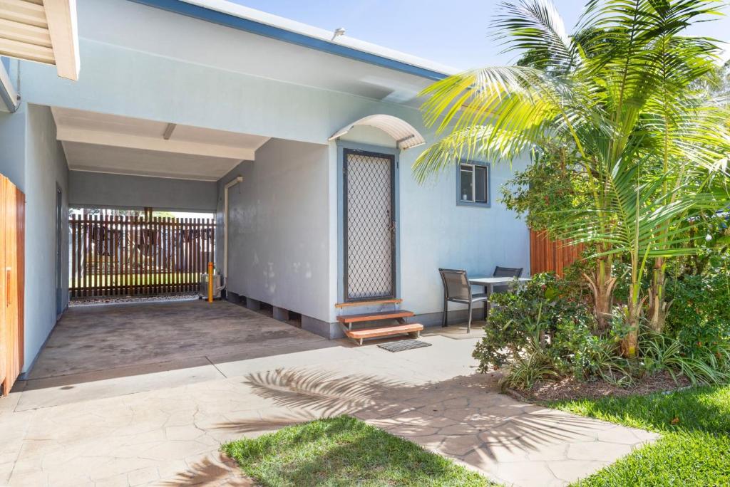 a porch of a house with a palm tree at Koala Lodge Studio 1 in Iluka