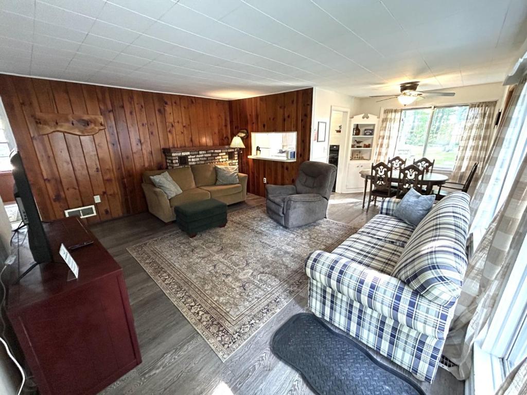 a living room with a couch and chairs and a table at Hidden Haven Cottages in Lake City