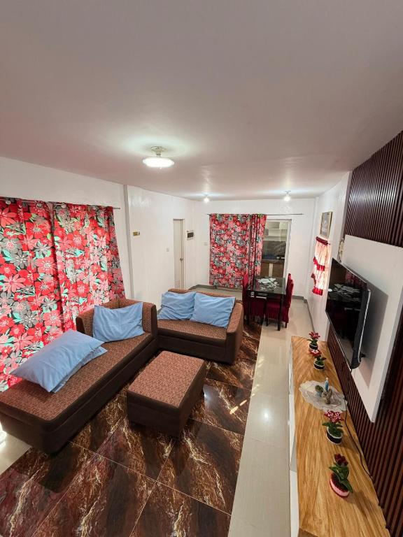 a living room with two couches and a table at Casa Saturnino Private Staycation 